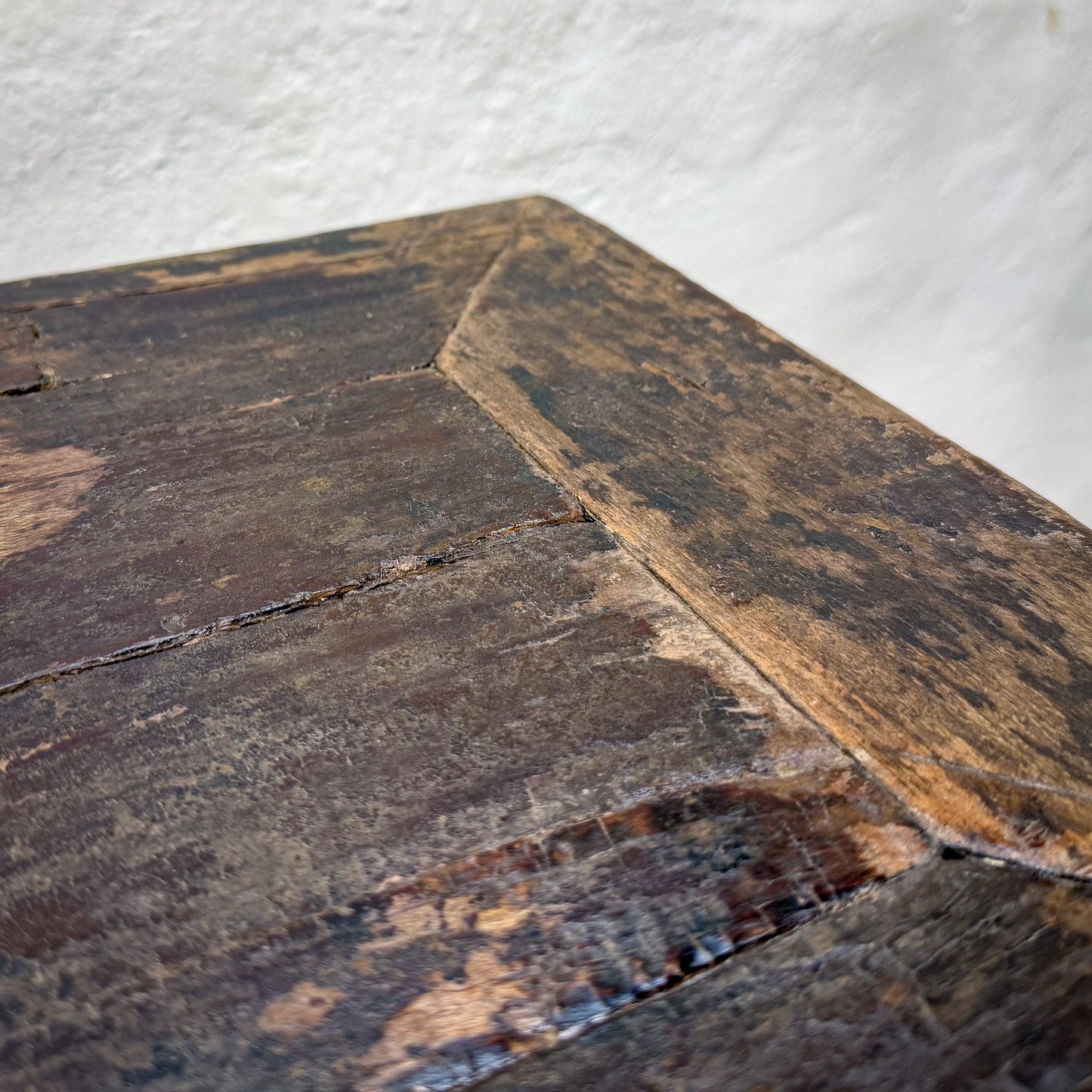 Close-up of an old, worn wooden surface with a textured background