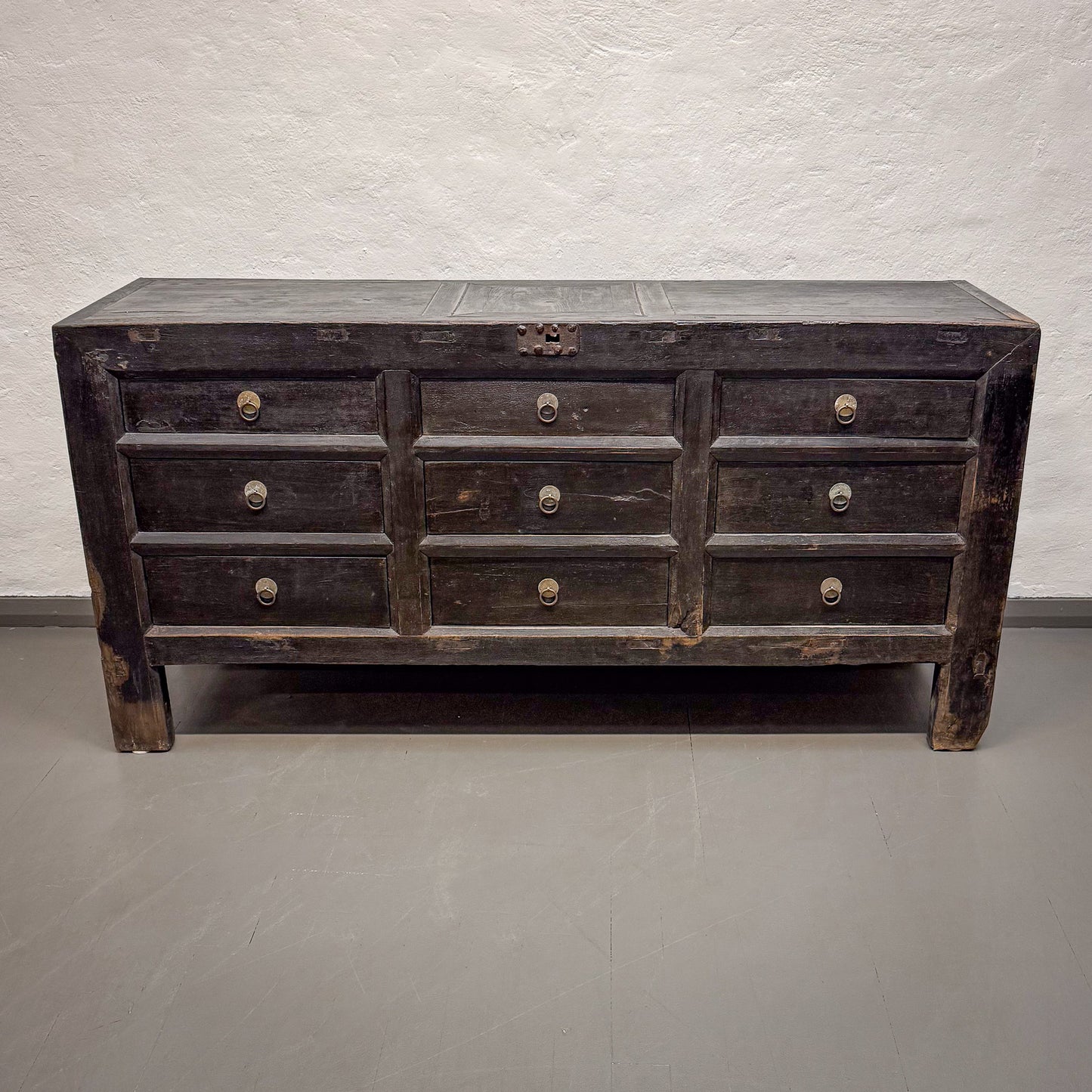 Vintage wooden dresser with multiple drawers on a plain background