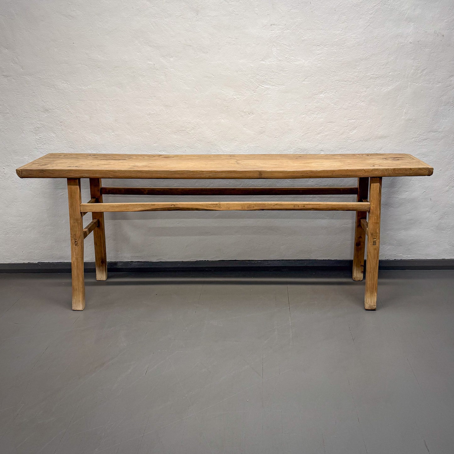 Wooden table against a plain wall