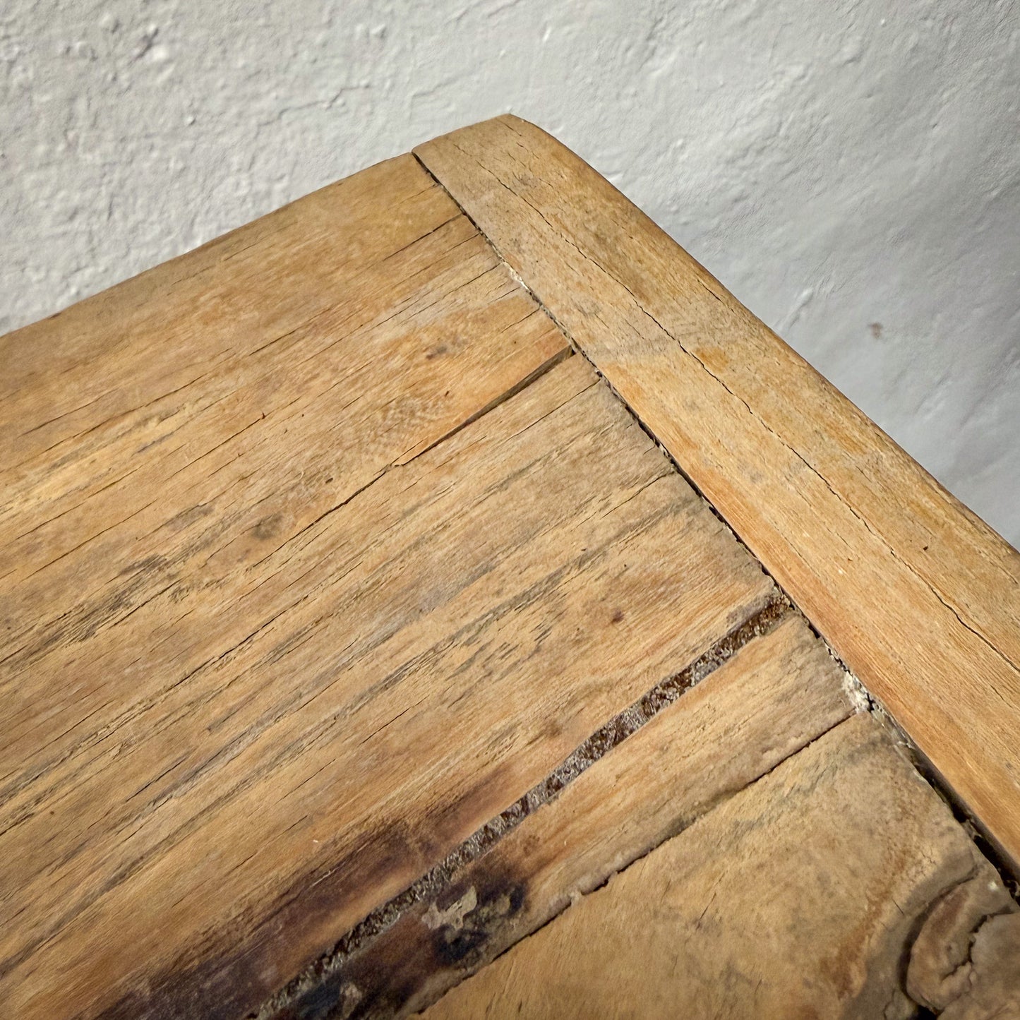 Close-up of a wooden surface with visible grain and texture.