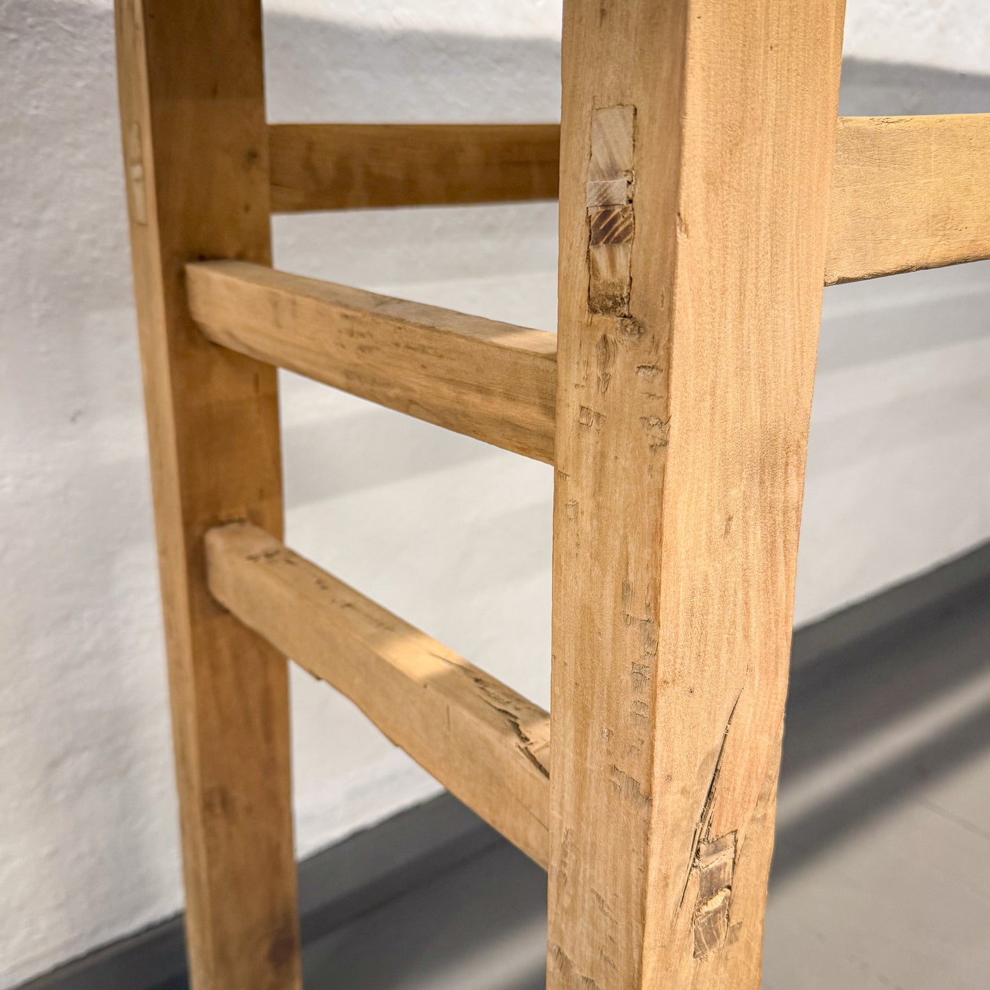 Close-up of a wooden ladder with a blurred background