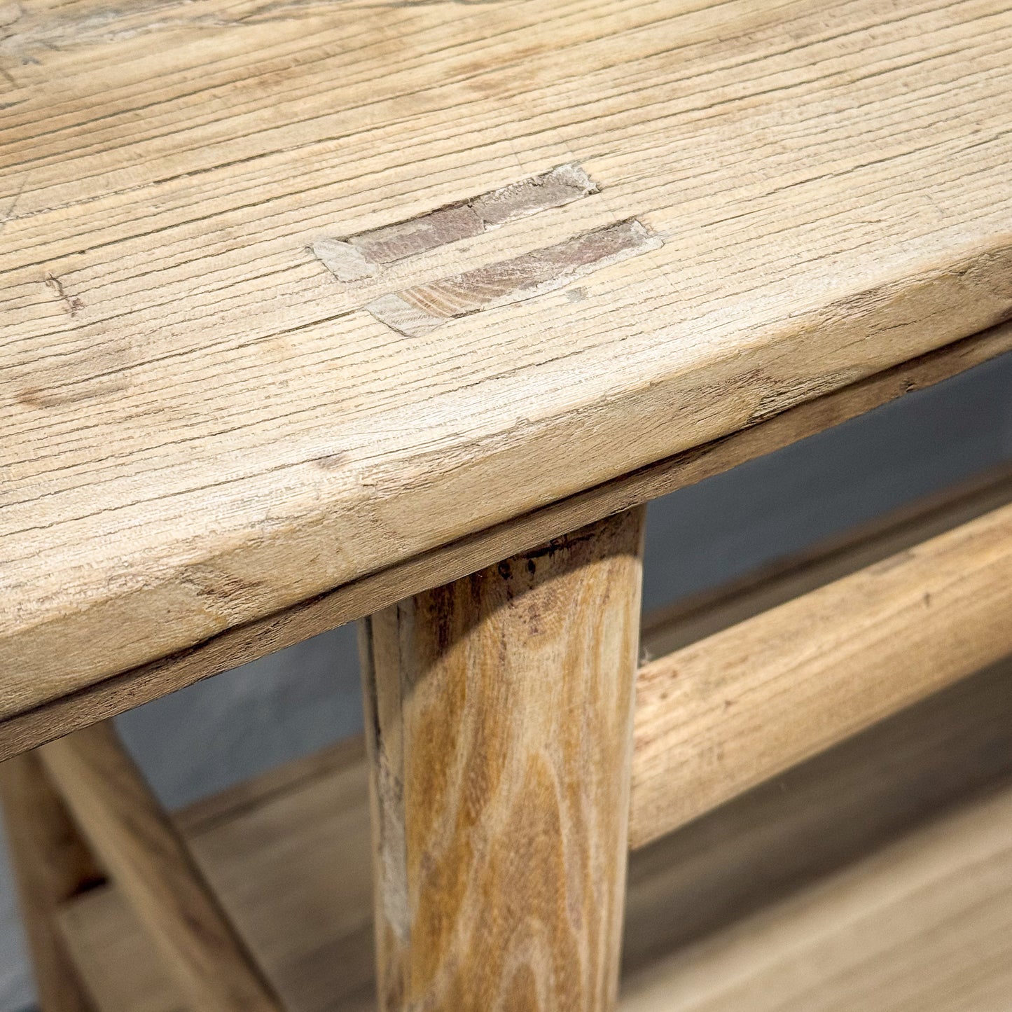 Close-up of a wooden table with visible grain and texture.