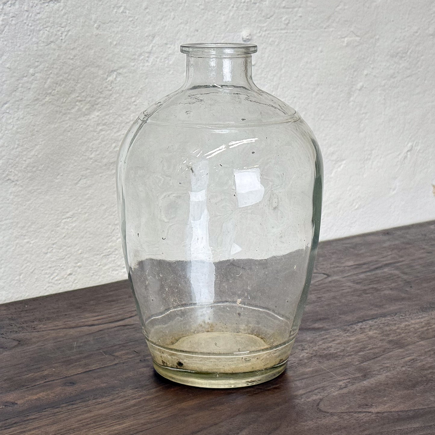 Clear glass vase on a textured white background