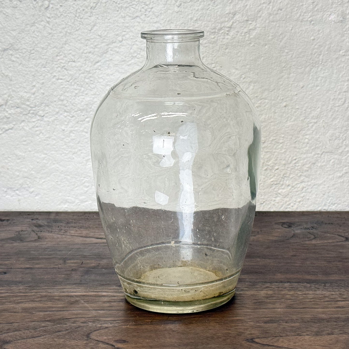 Clear glass vase on a textured white background