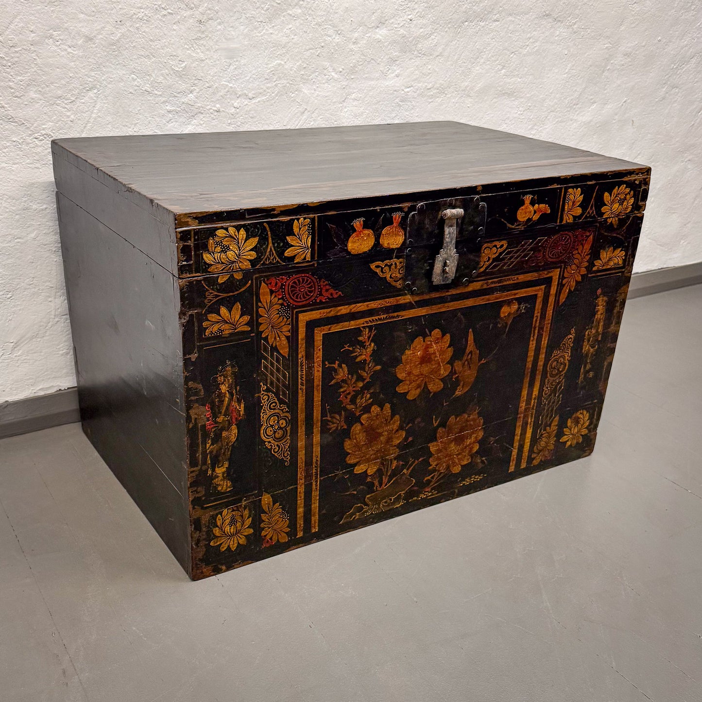 Decorative wooden chest with floral patterns on a plain background