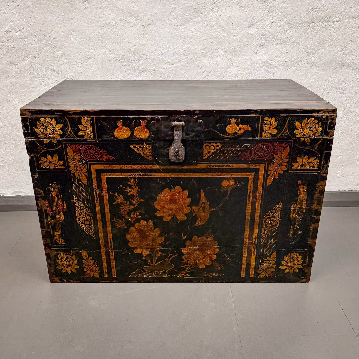 Decorative wooden chest with floral patterns on a plain background