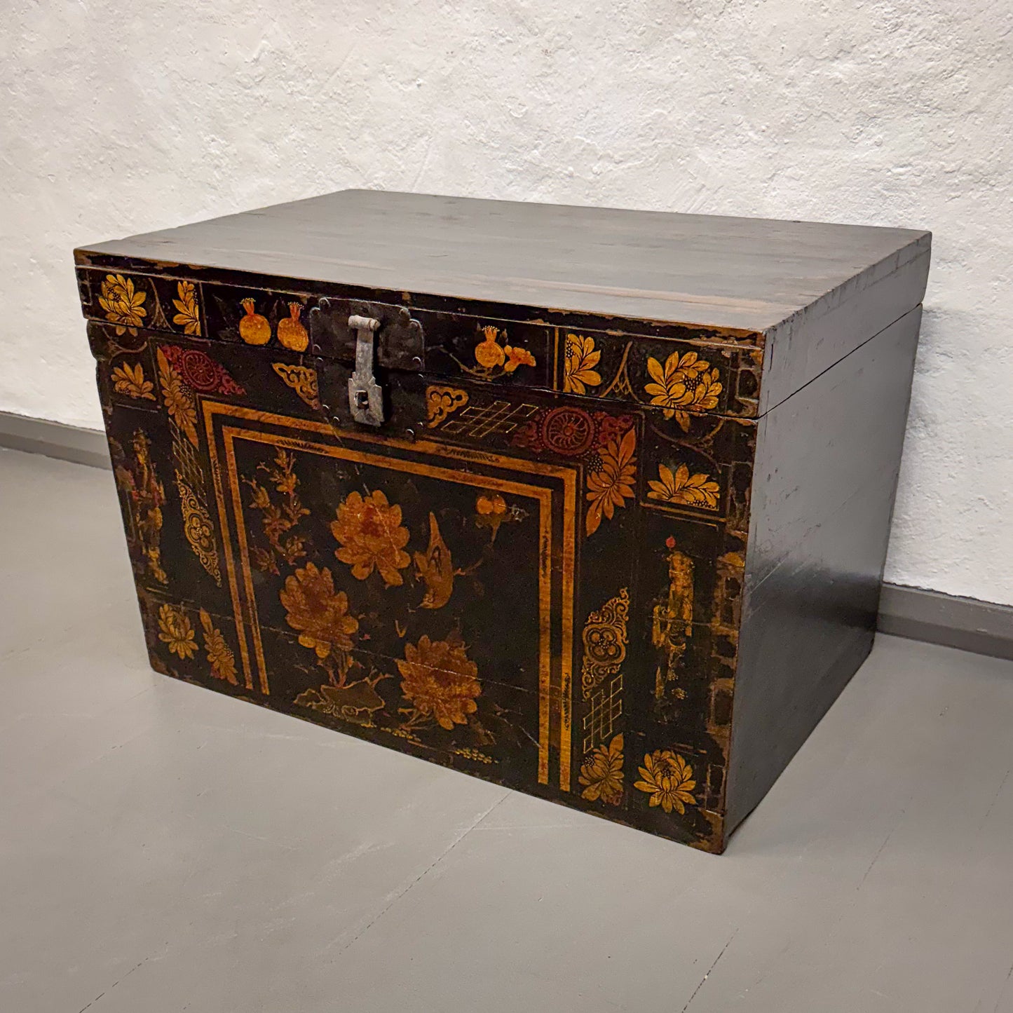 Decorative wooden chest with floral patterns on a plain background