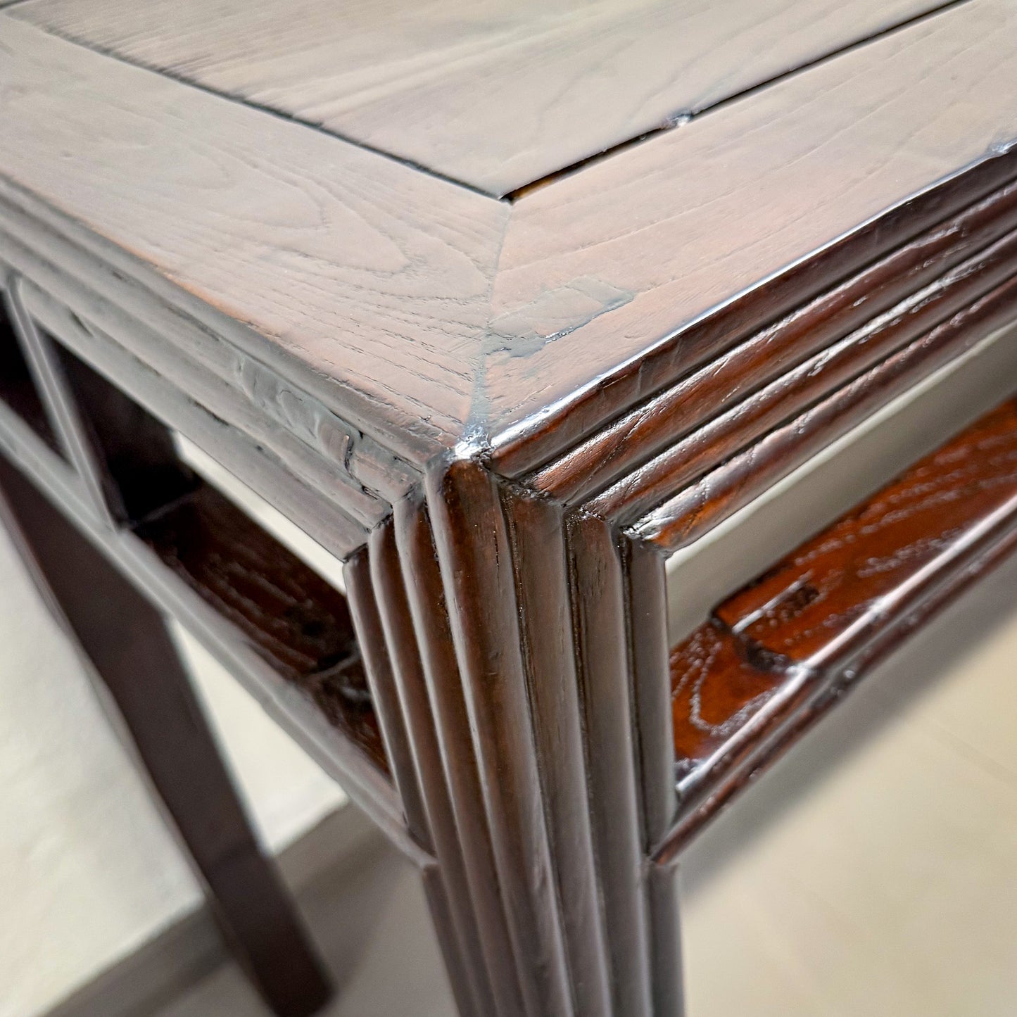 Close-up of a wooden surface with a reflective metallic strip