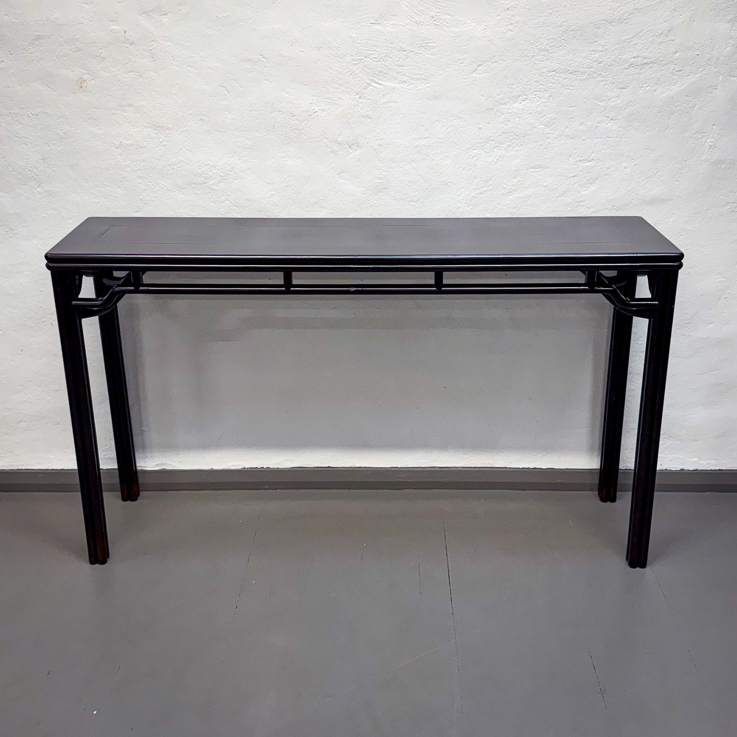 Black table against a white wall