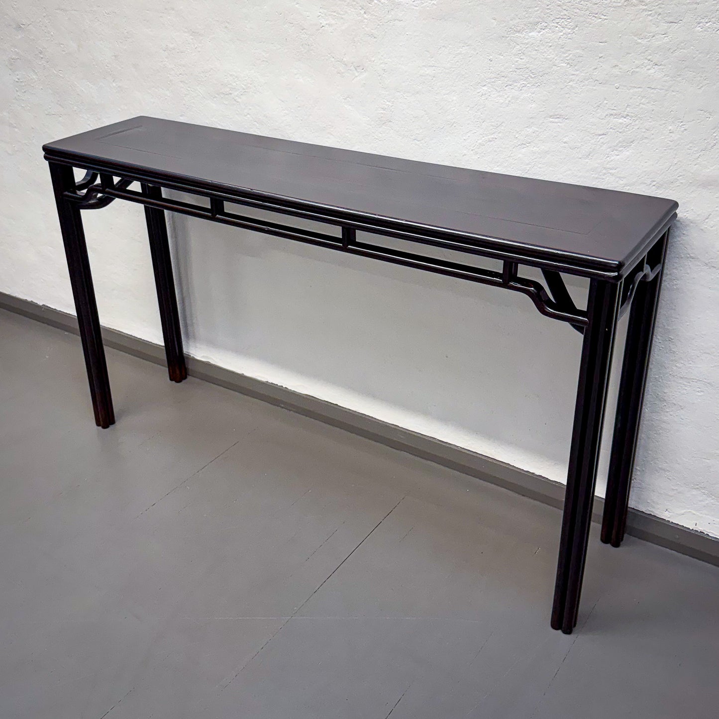 Black console table against a white wall