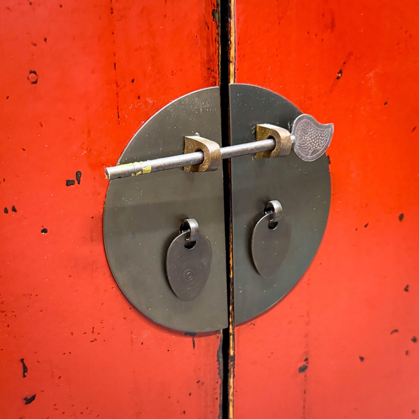 Metallic door handle on a red door