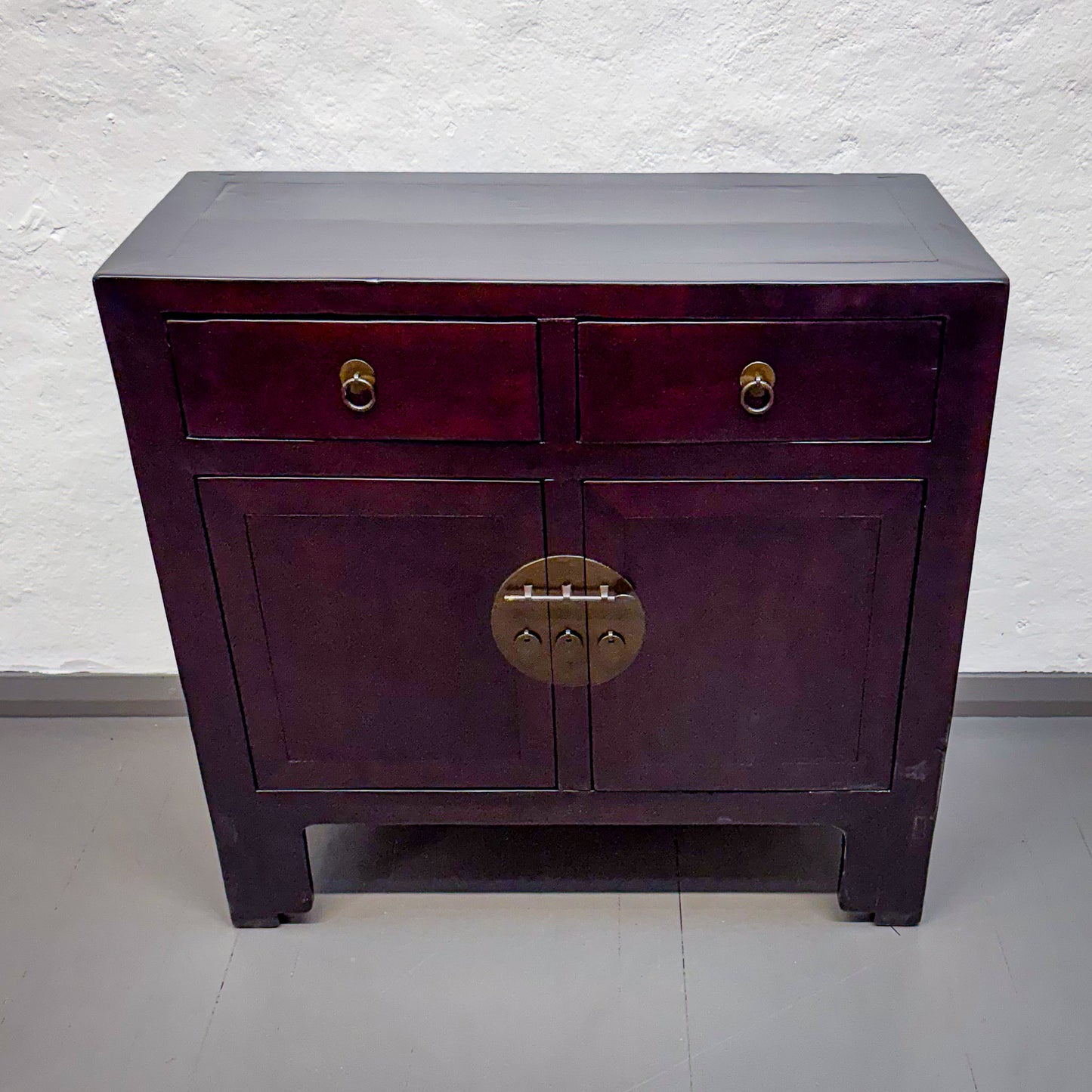 Purple cabinet with gold accents on a white background