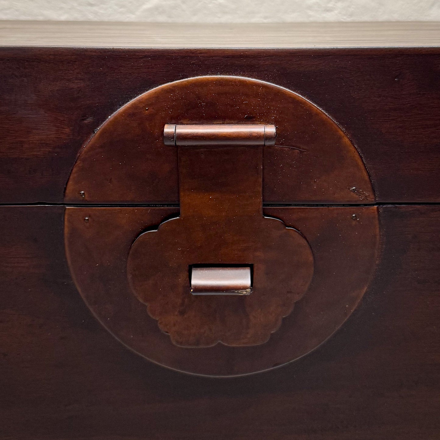 Close-up of a wooden chest with a metal latch