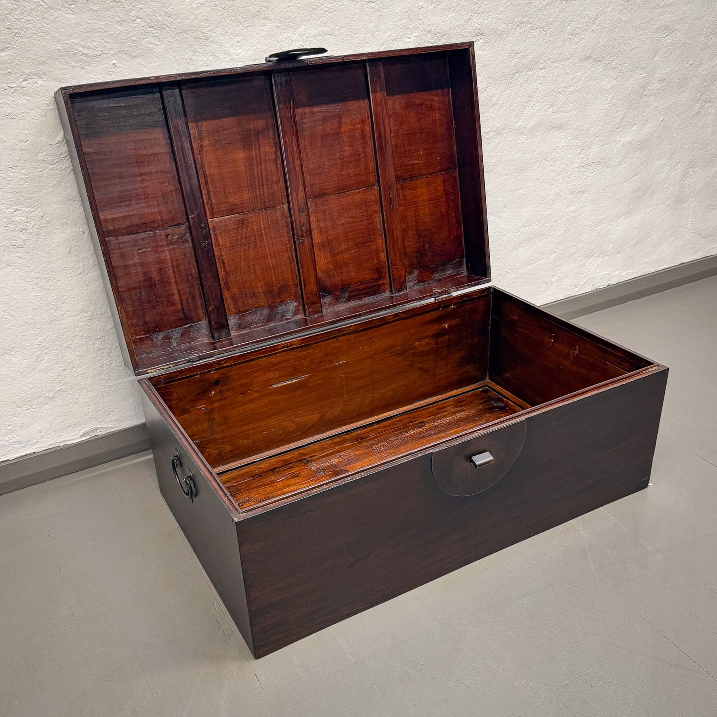 Wooden storage trunk with a textured wall and floor background