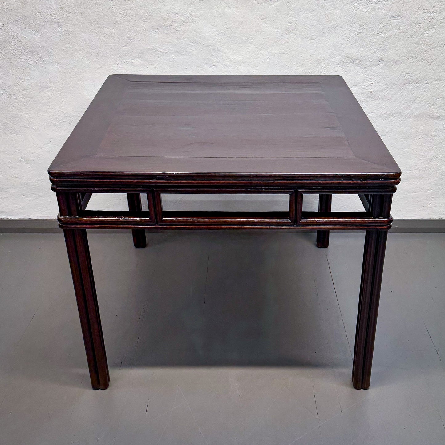 Wooden table with a dark finish on a plain background