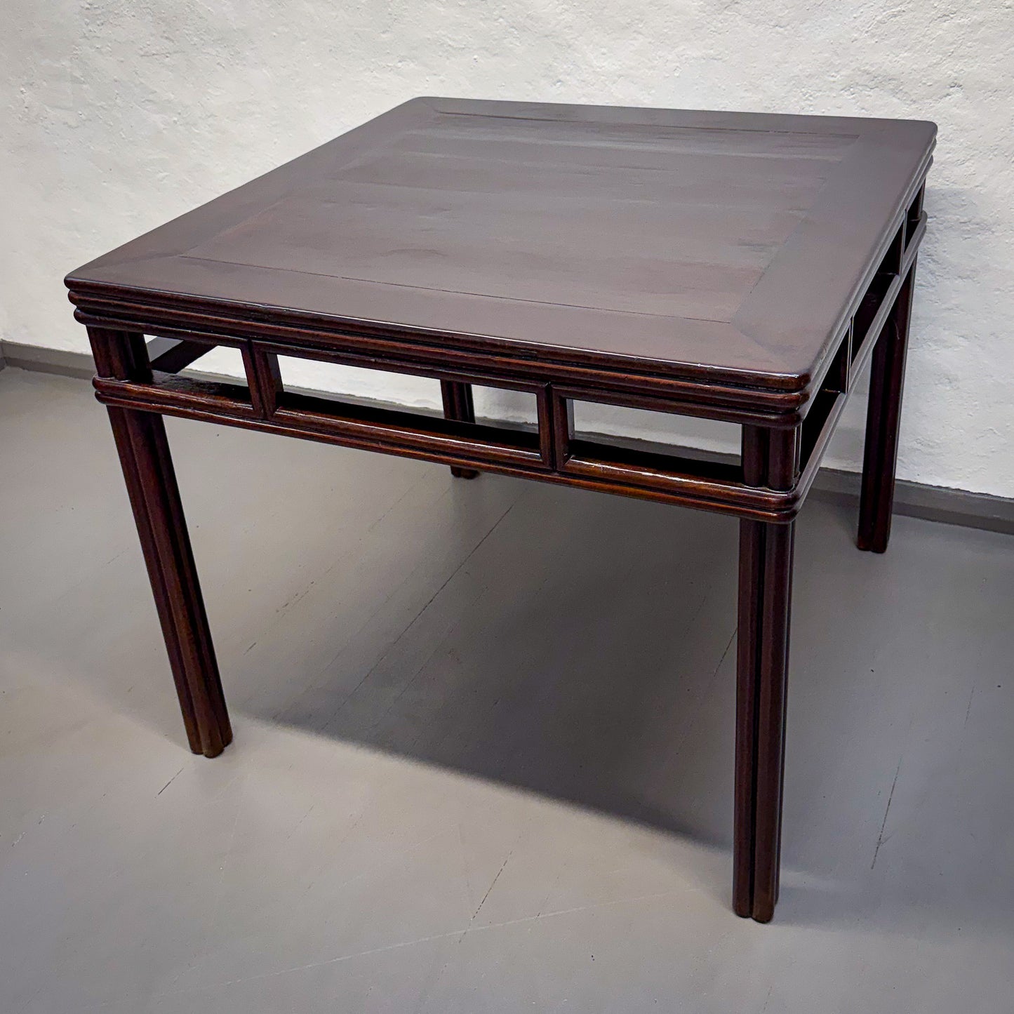 Wooden table with a dark brown finish on a plain background
