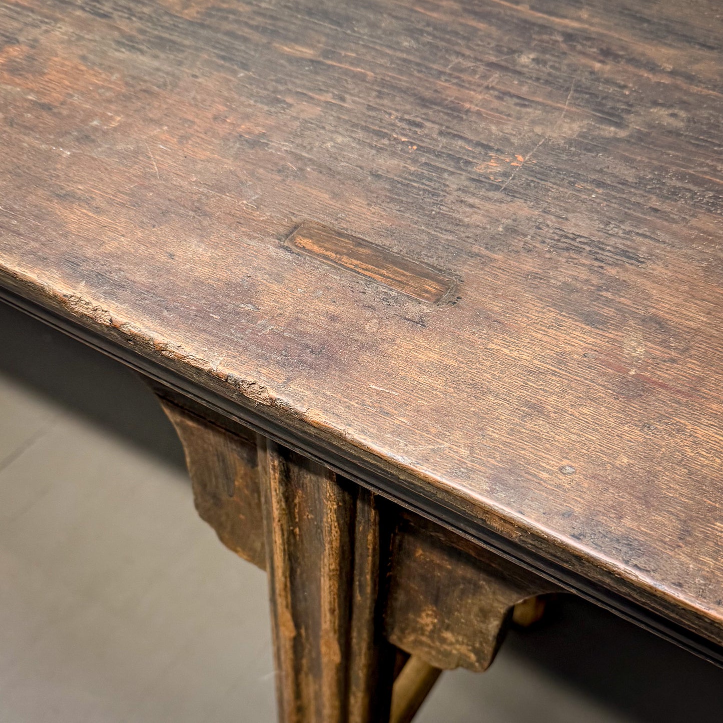 Close-up of a wooden table with visible wear and tear