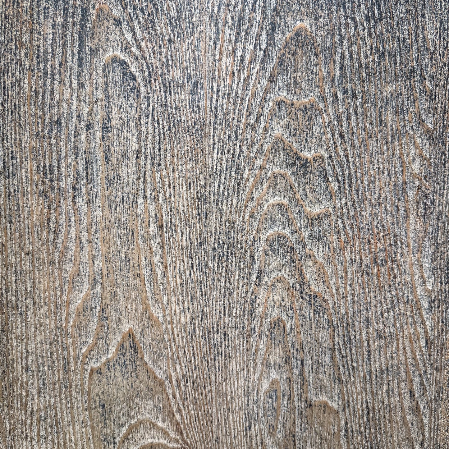 Close-up of a textured wooden surface with grain patterns