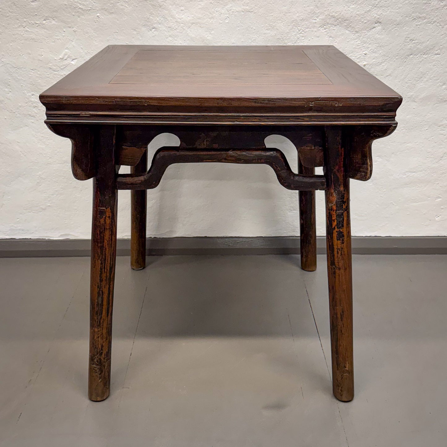 Wooden table with a textured surface on a plain background