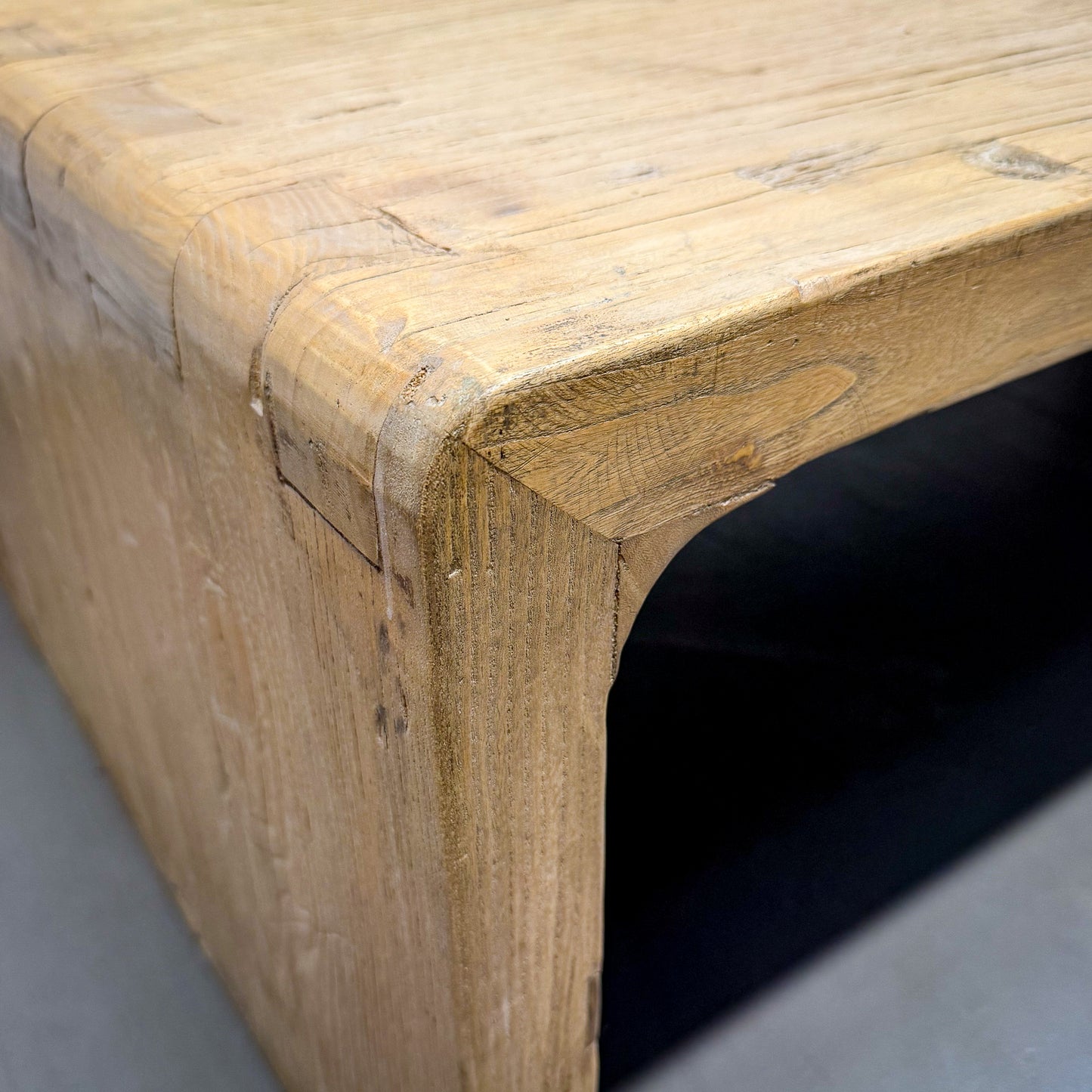 Close-up of a wooden bench with visible grain and texture.
