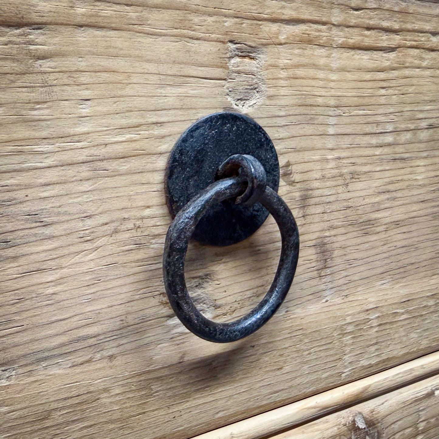 Rustic wooden door with a metal ring handle