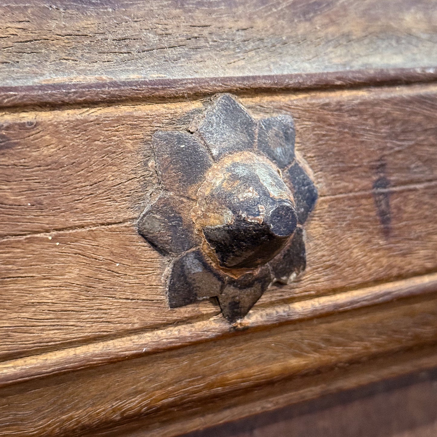 Decorative metal flower on a wooden surface