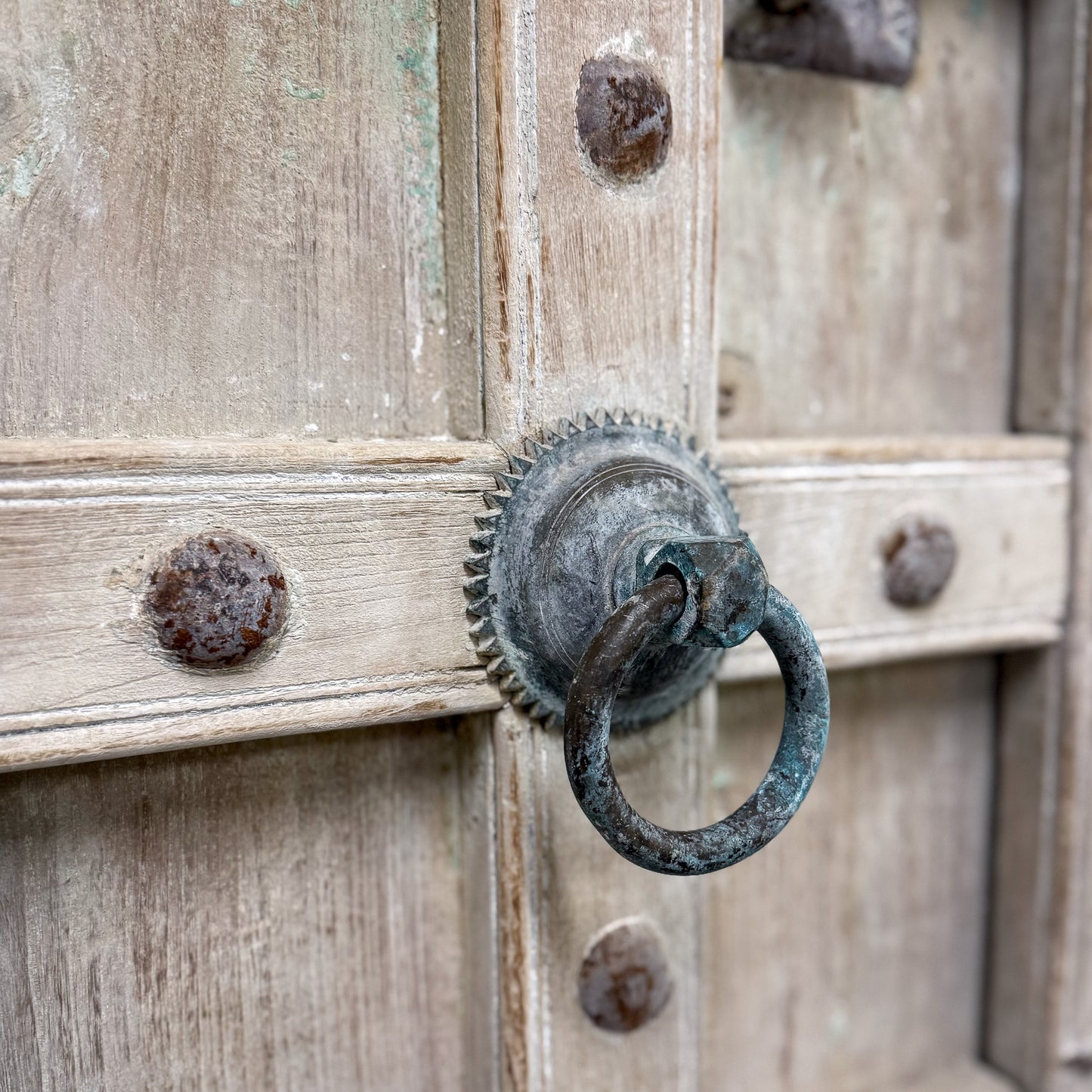 Vintage wooden door with a metal handle and decorative elements