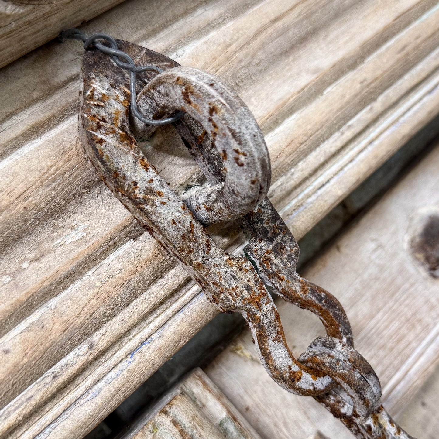 Rust-covered chain on a wooden surface