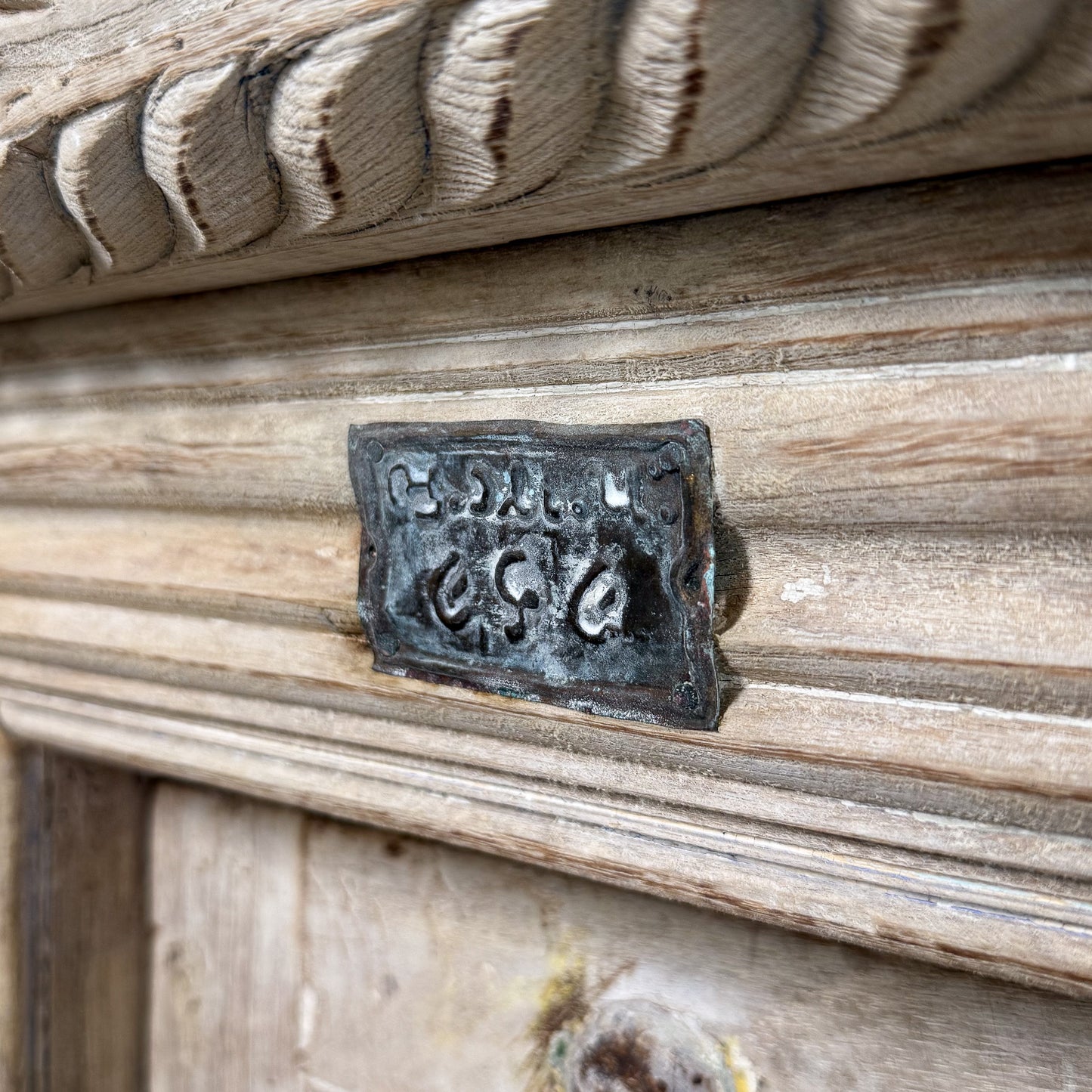 Metal plaque with engraved text on a wooden surface