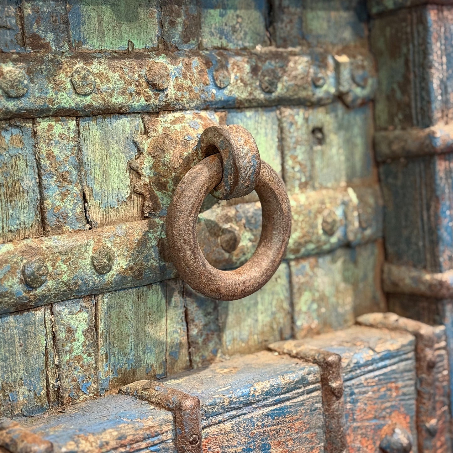 Rust-covered metal lock on an old, textured surface