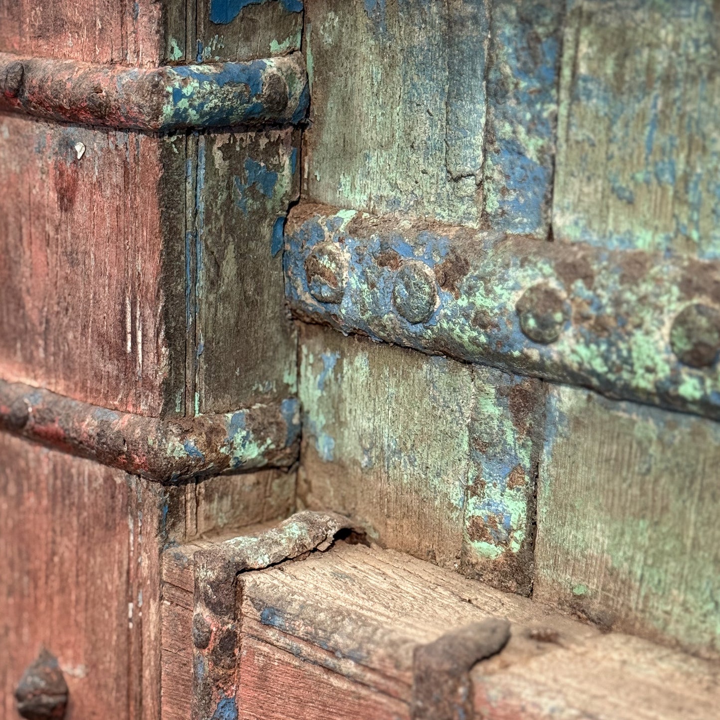 Close-up of a rusty metal lock with greenish patina
