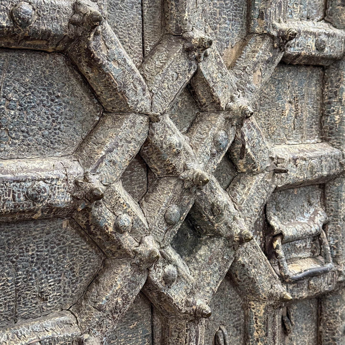 Close-up of intricate stone carvings on a textured surface