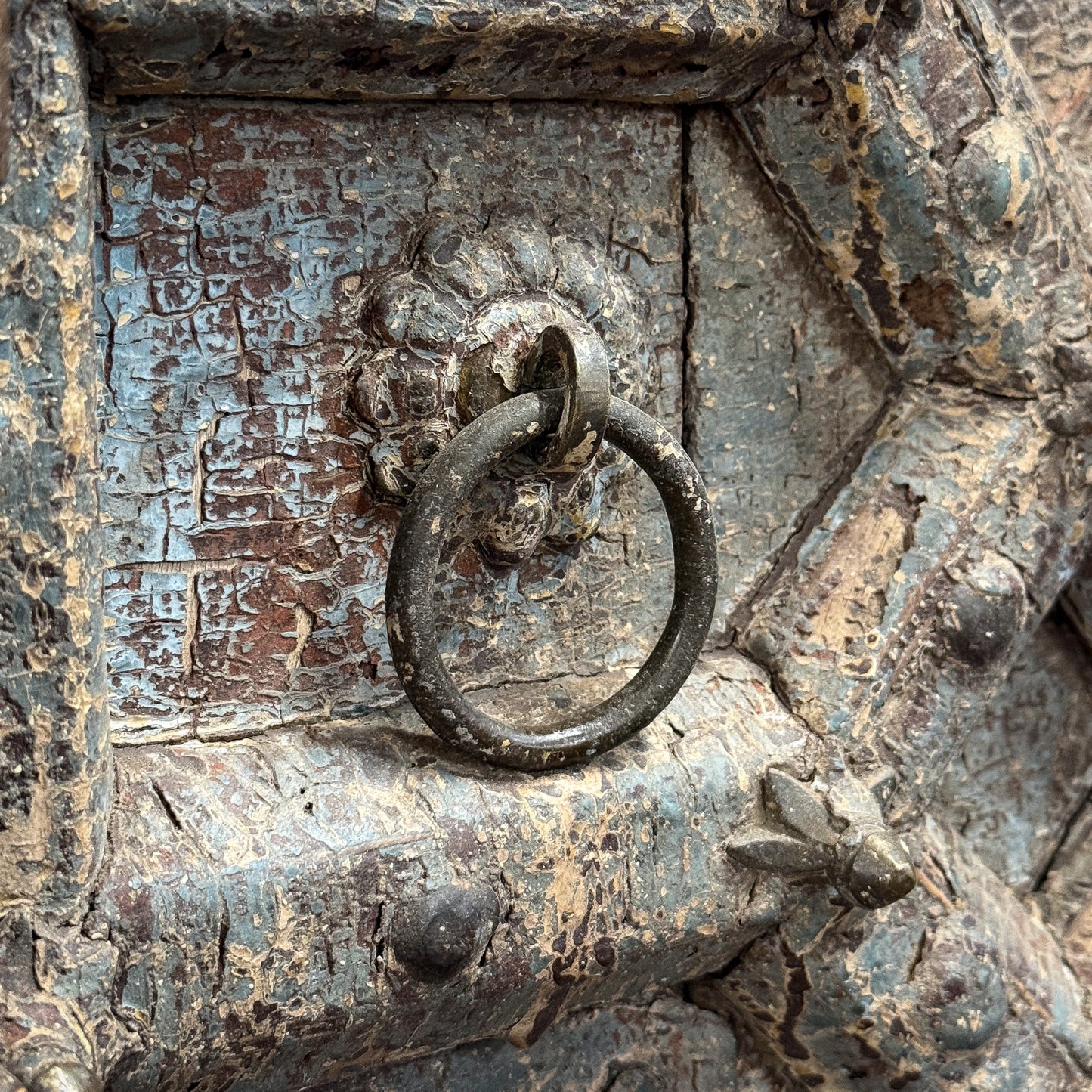 Rust-covered metal handle on an old door