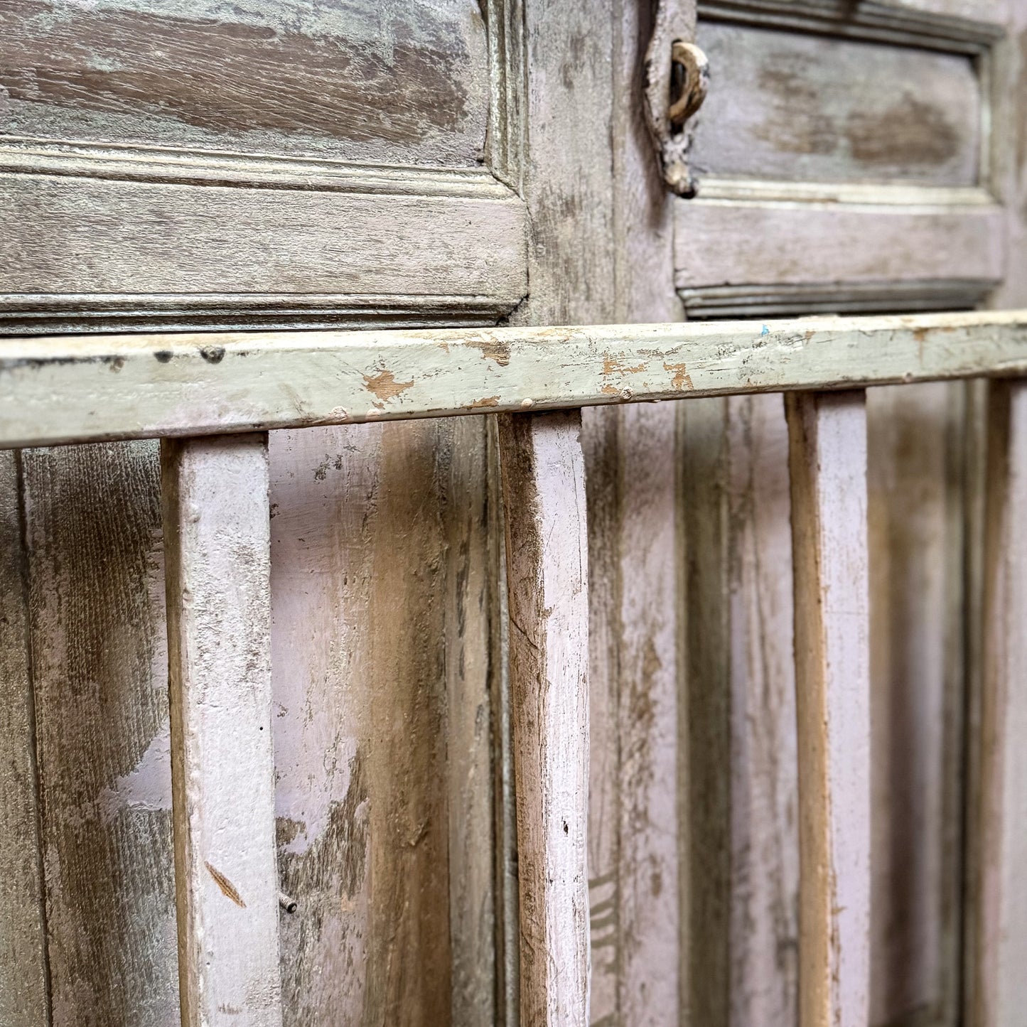 Close-up of a weathered wooden cabinet with peeling paint