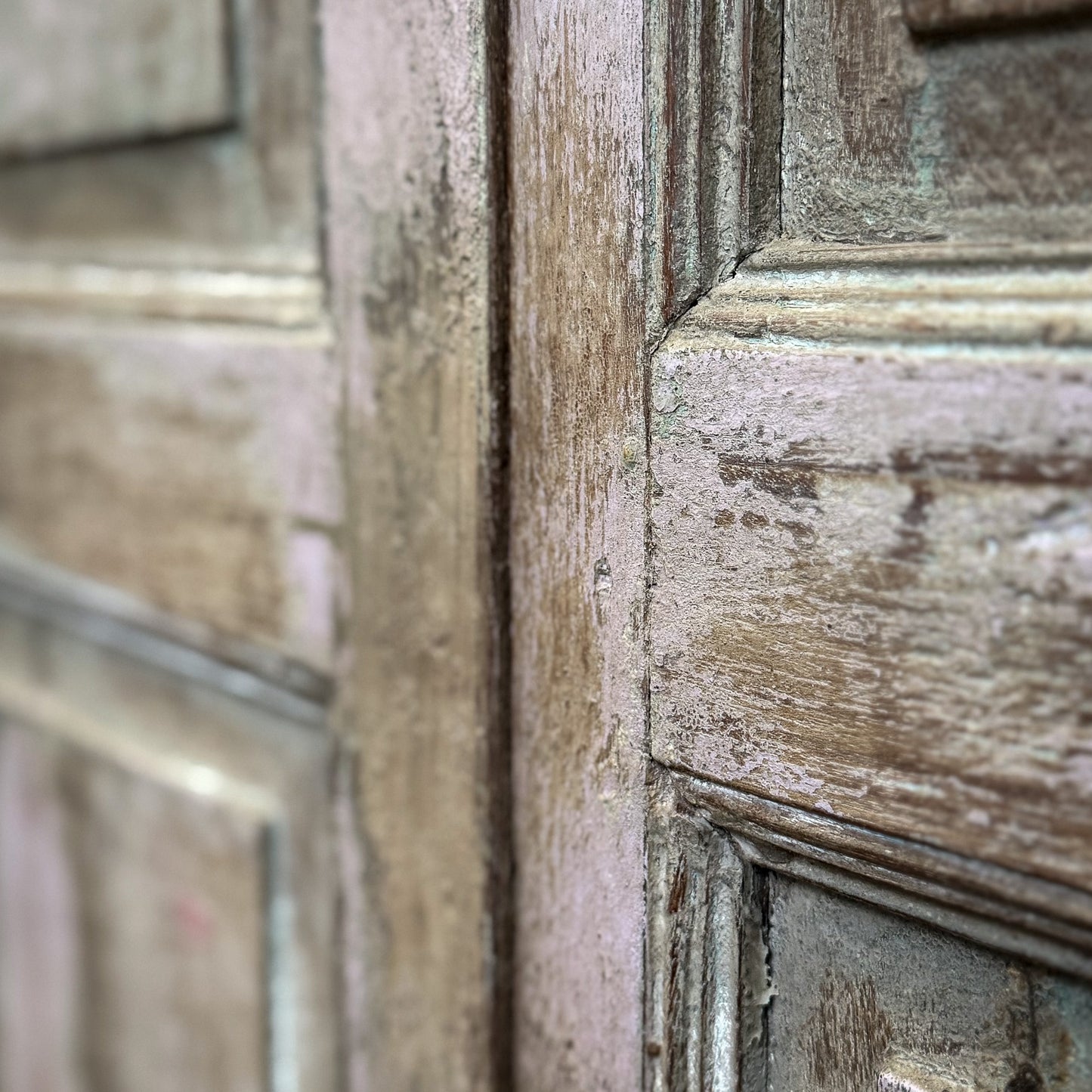 Close-up of an old wooden door with visible wear and tear.