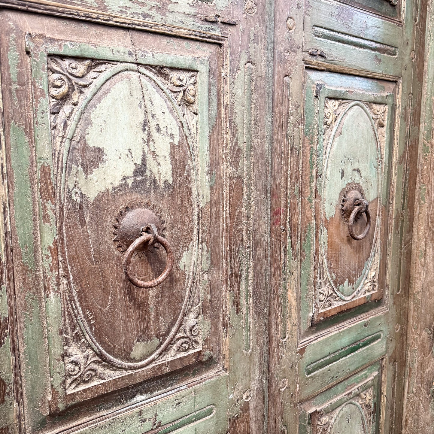 Vintage wooden door with metal handles and intricate carvings