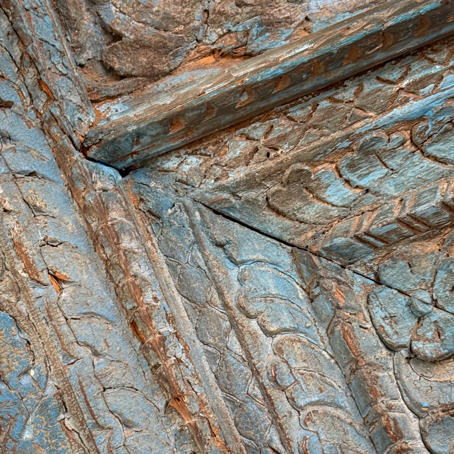 Close-up of stone carvings with intricate patterns on a wall.