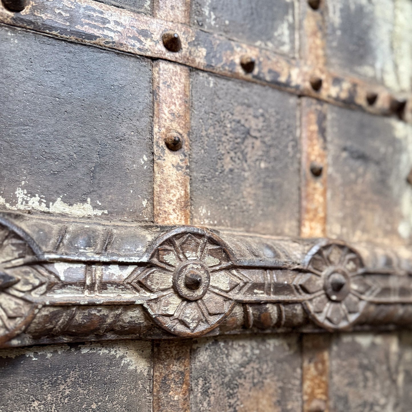 Close-up of ornate metalwork on a textured surface