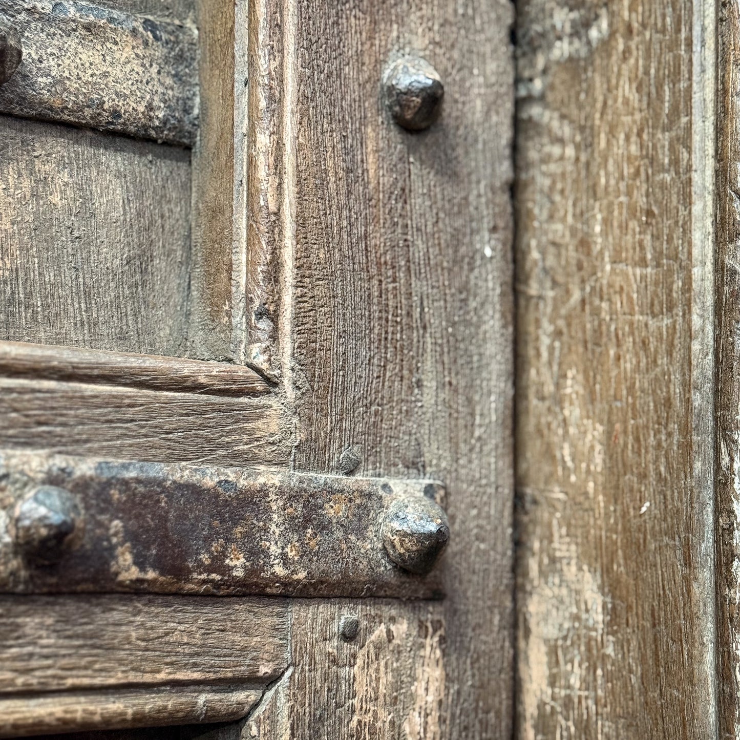 Close-up of a wooden door with metal reinforcements