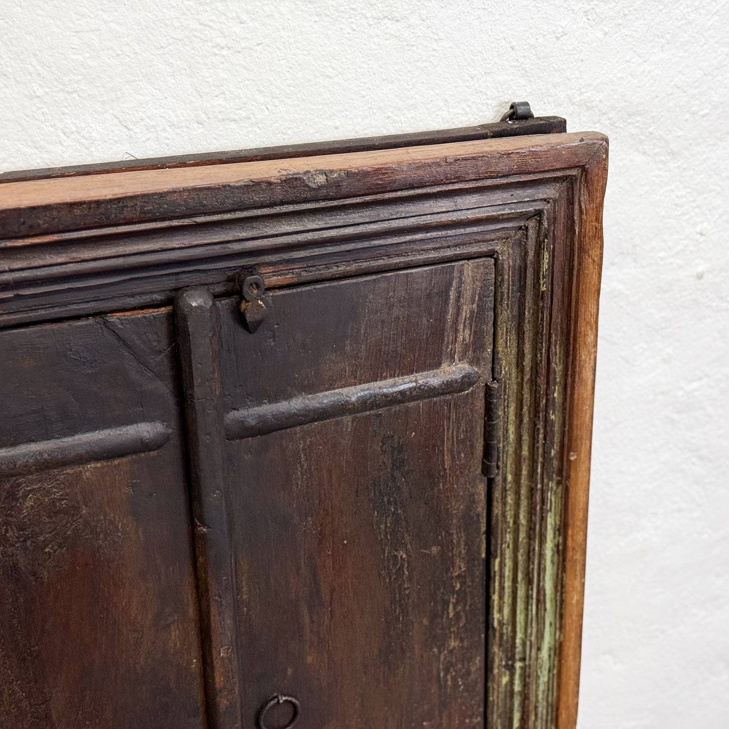 Close-up of an old wooden cabinet with a white background