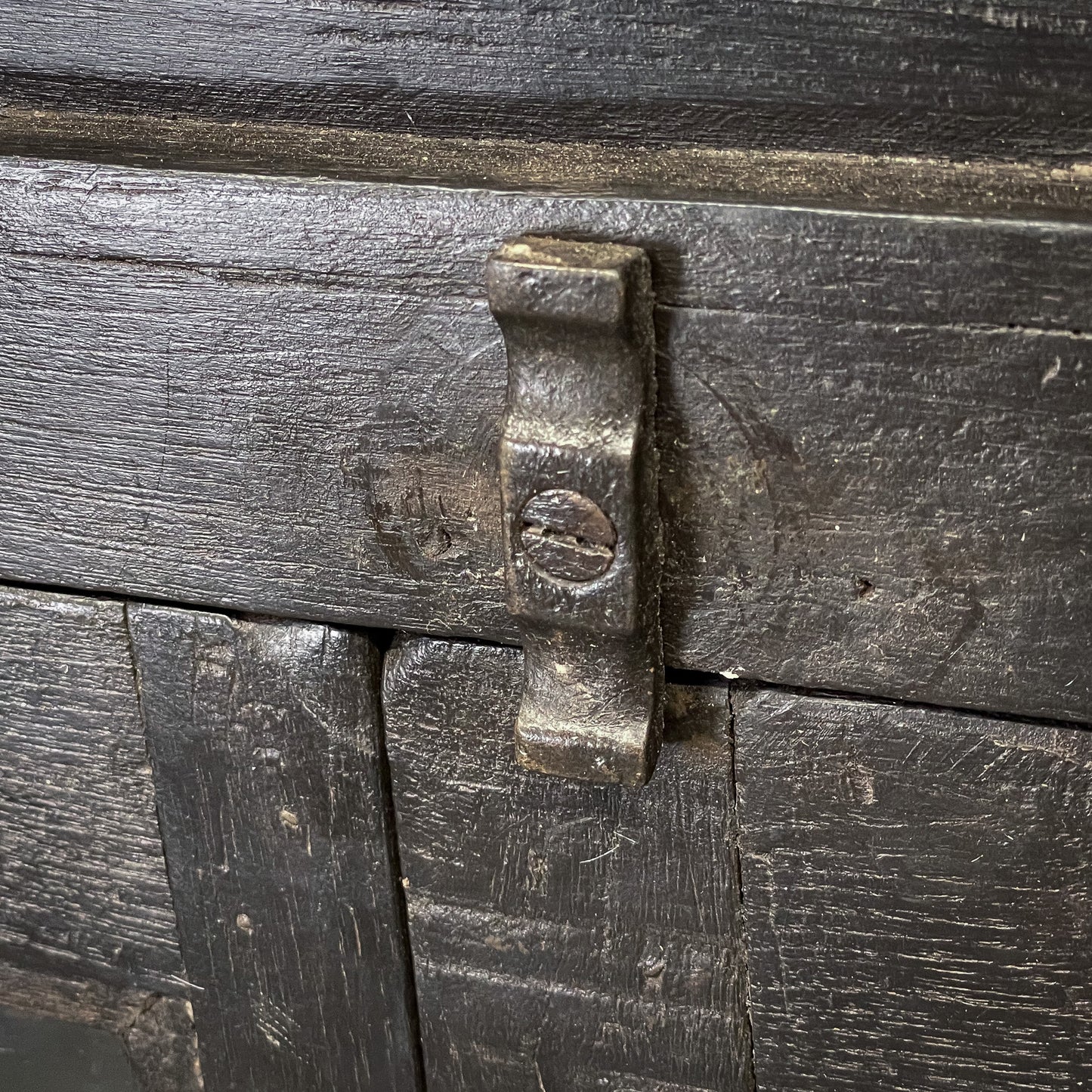 Close-up of a wooden chest with a metal latch