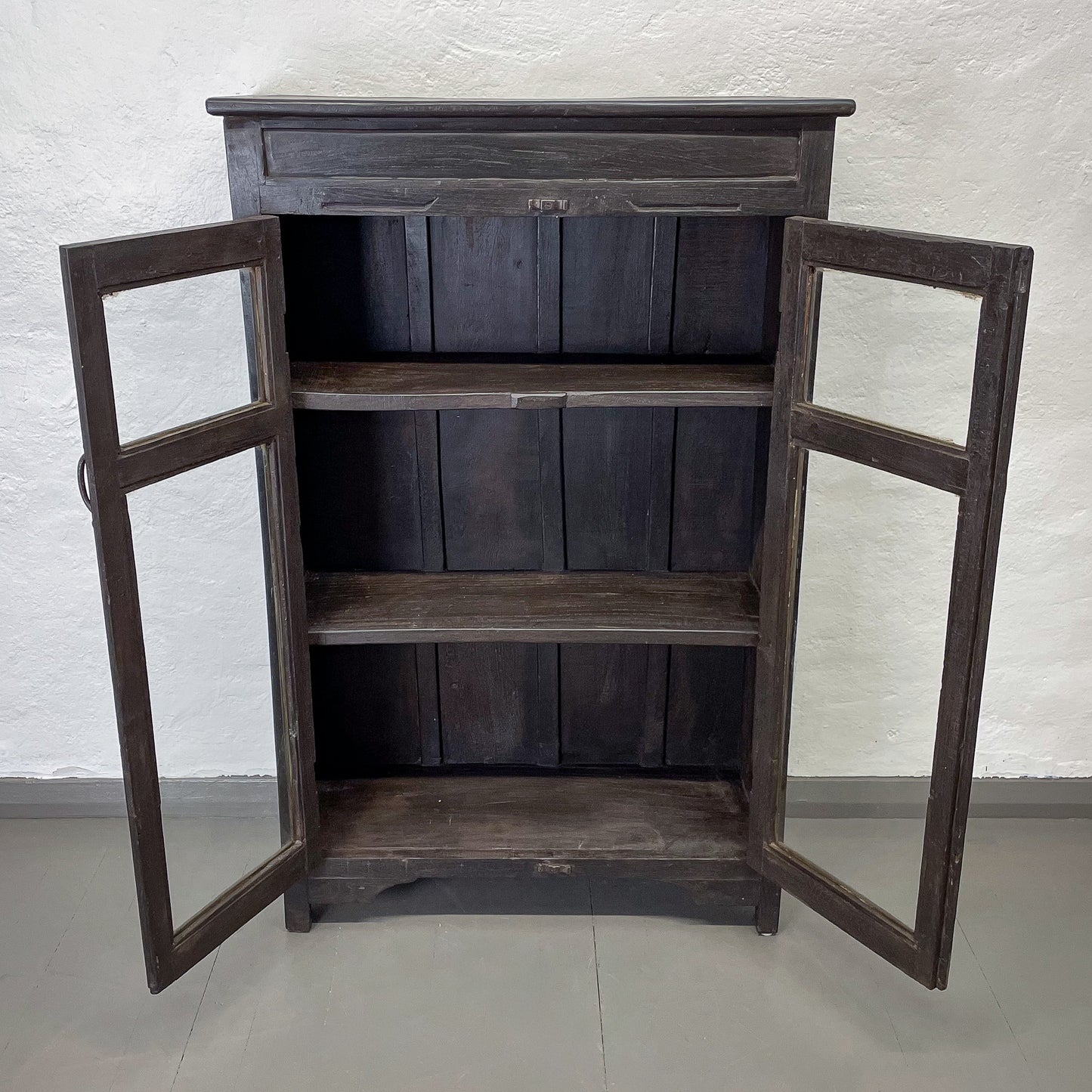 Wooden cabinet with glass doors on a white background