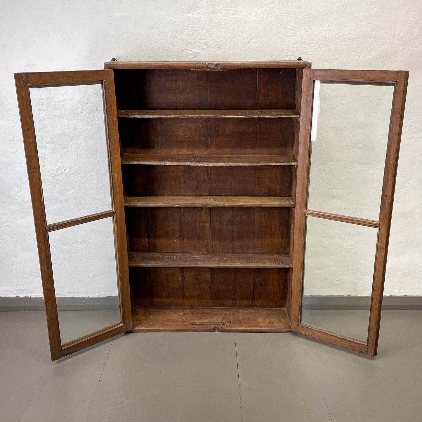 Wooden cabinet with mirrored doors on a plain background