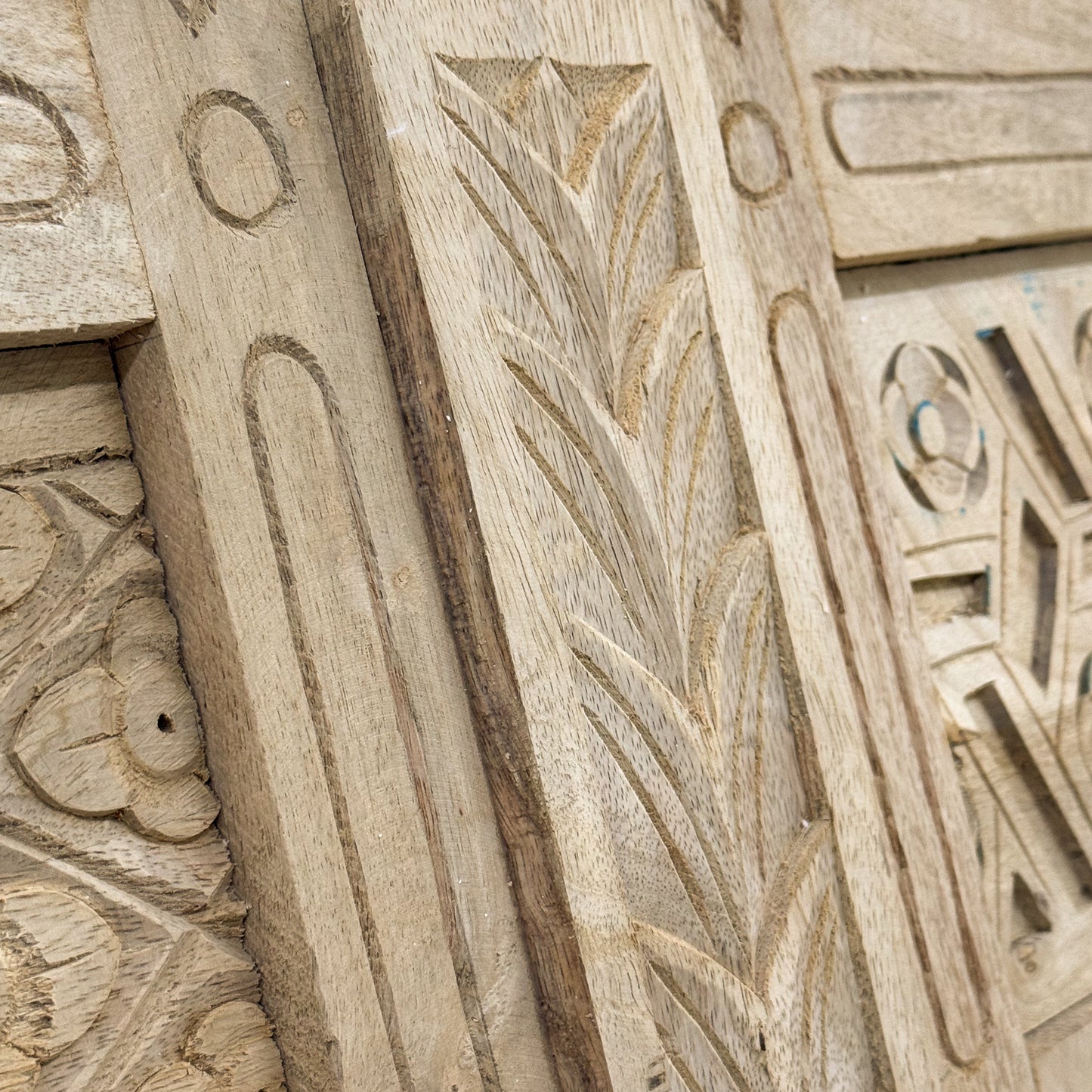 Close-up of intricately carved wooden panel with geometric patterns