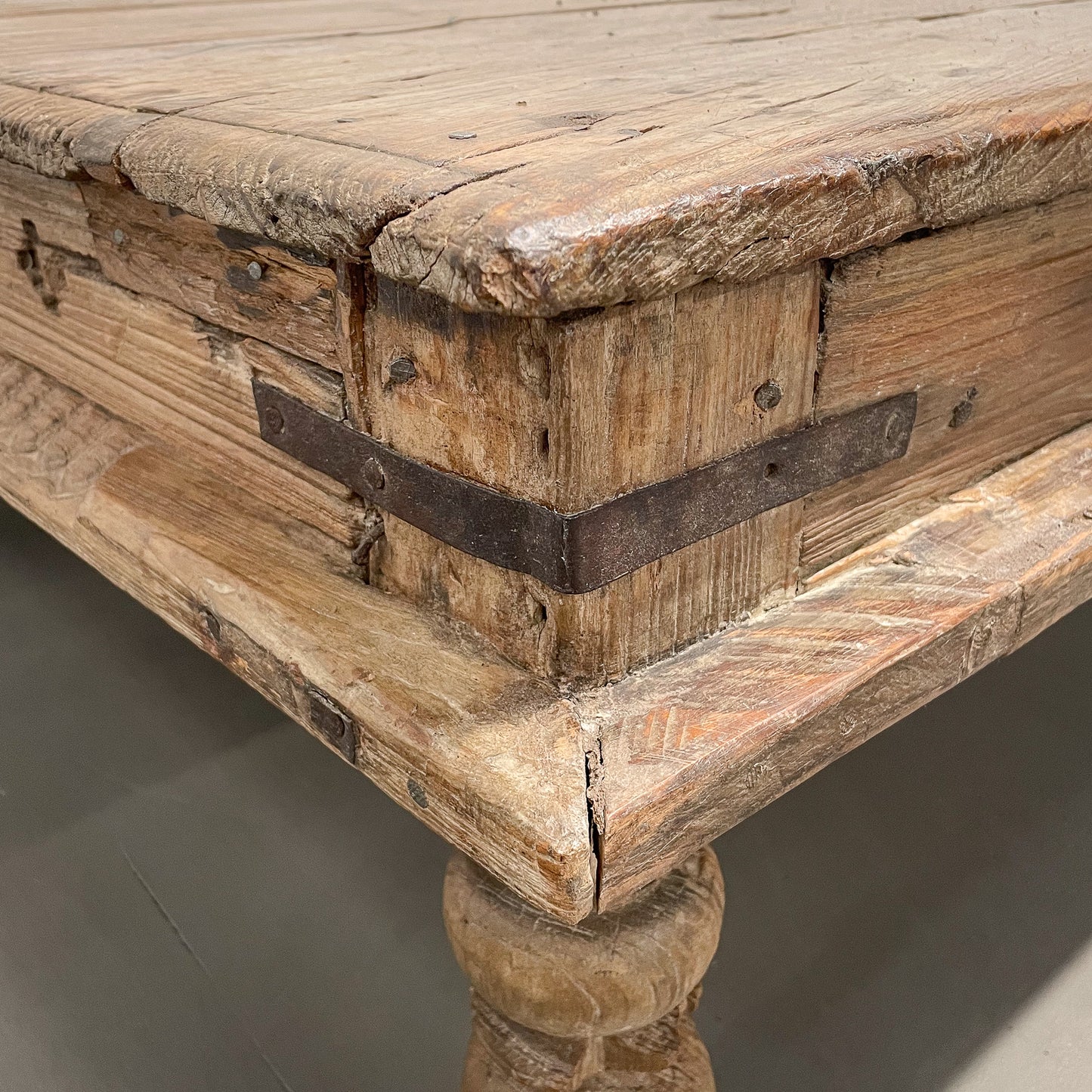 Close-up of a wooden surface with a stone ledge below