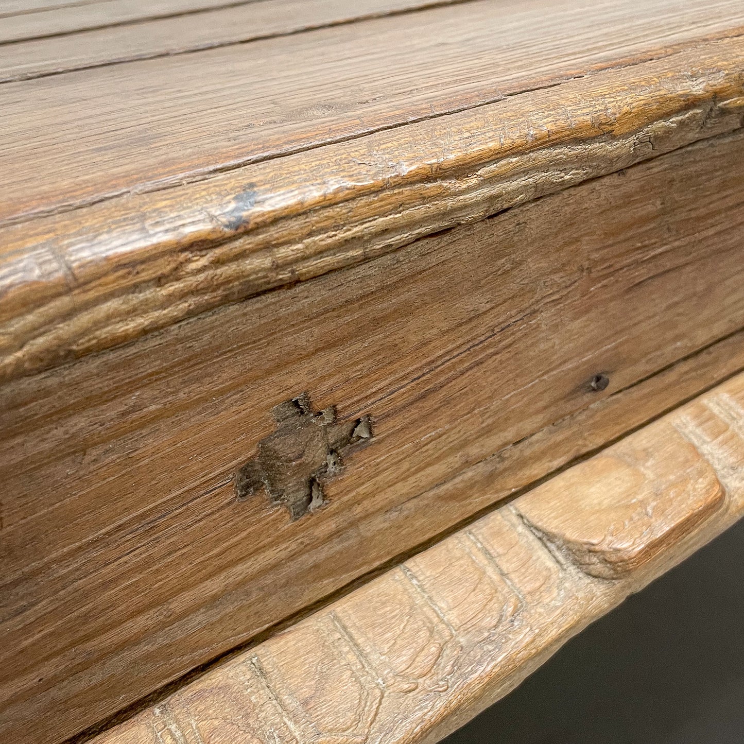 Close-up of a wooden surface with a stone ledge below