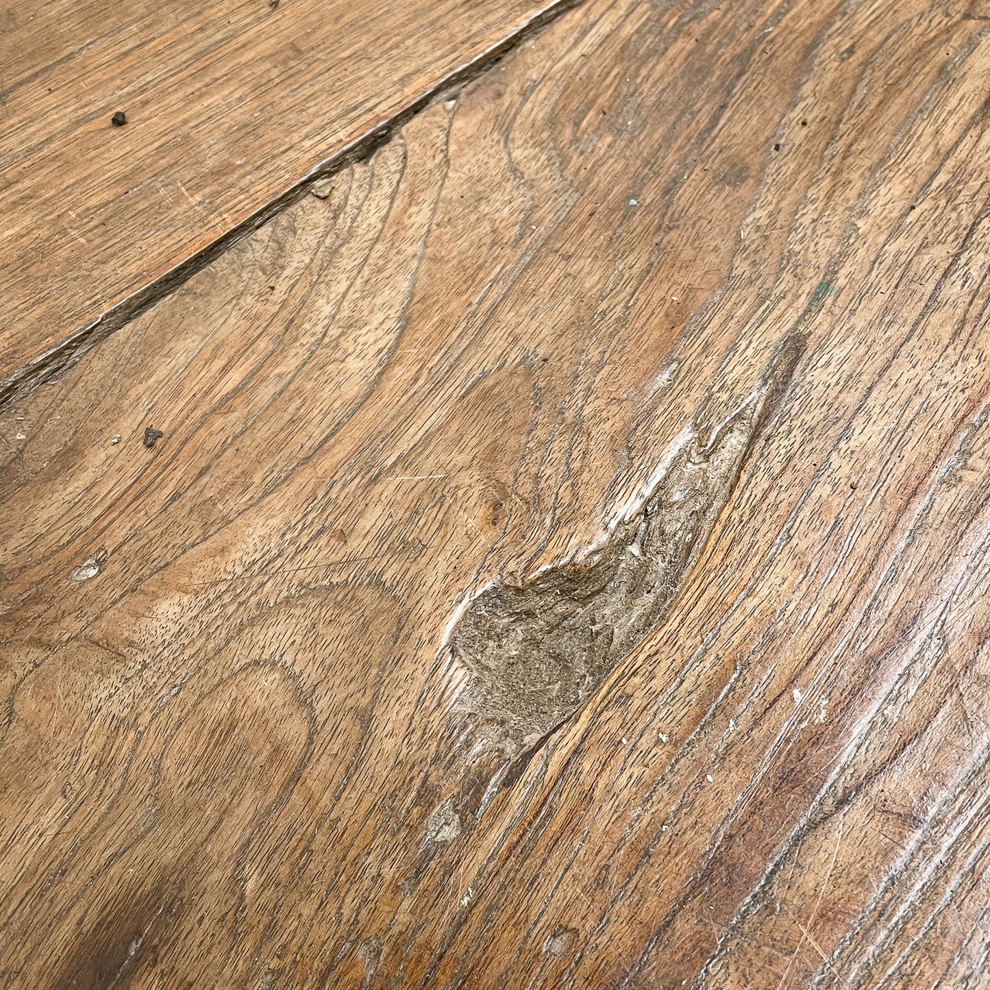 Close-up of wooden flooring with a focus on texture and color variation.