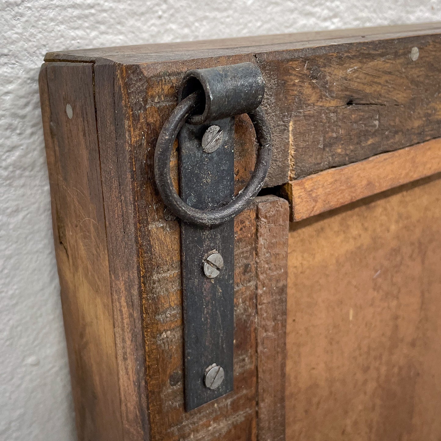 Close-up of a wooden door with a metal handle and lock mechanism.