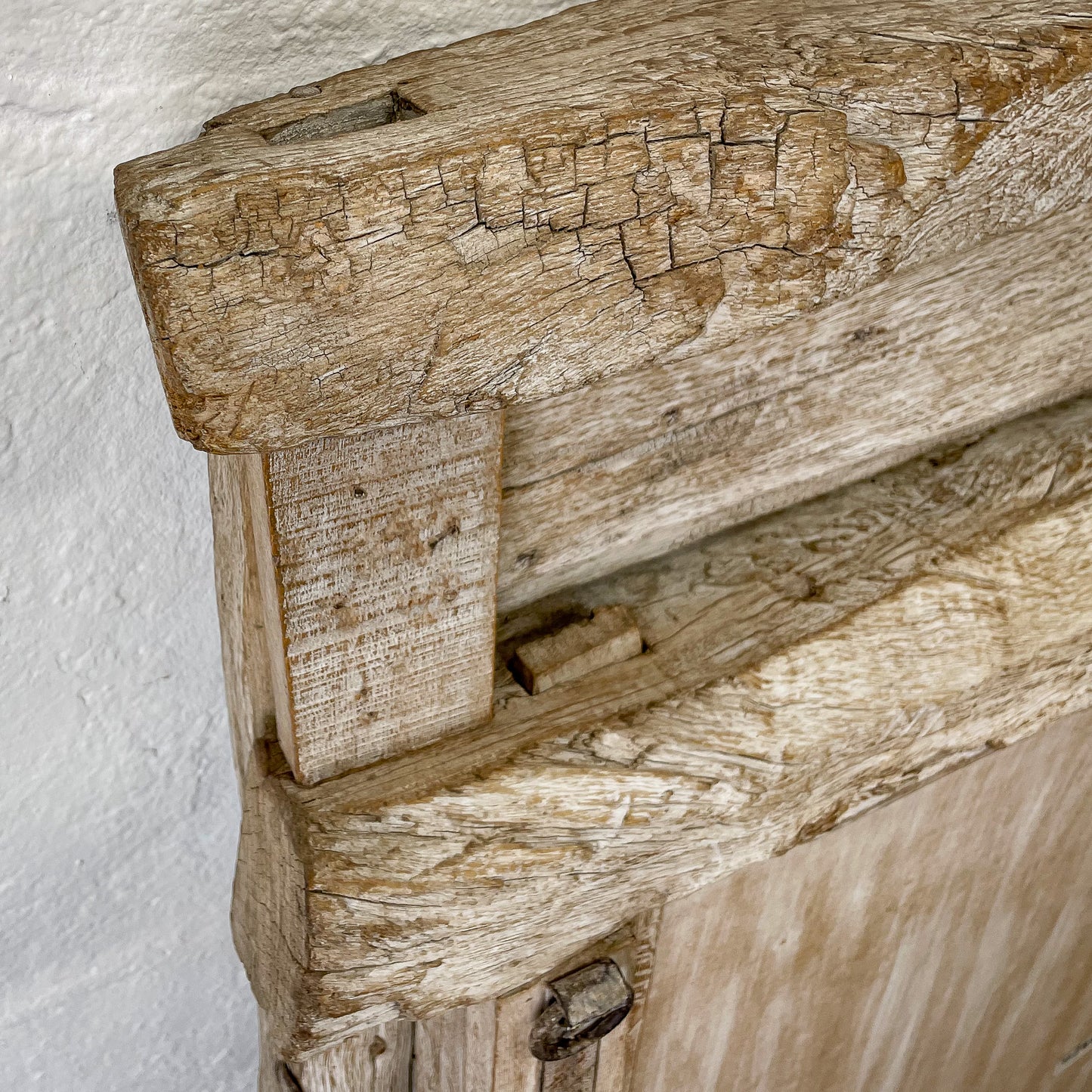 Close-up of a rustic wooden beam with visible grain and texture.