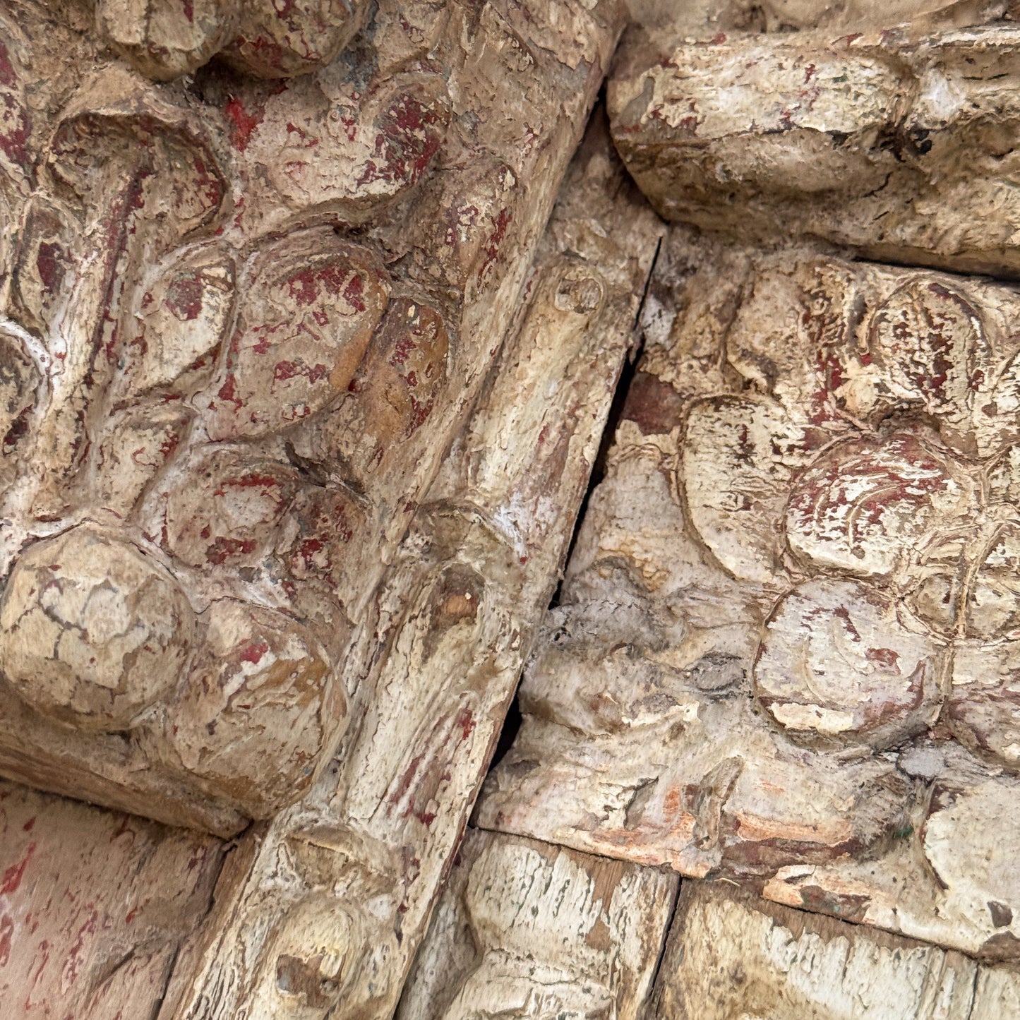 Close-up of stone architectural detail with intricate carvings and a crack.